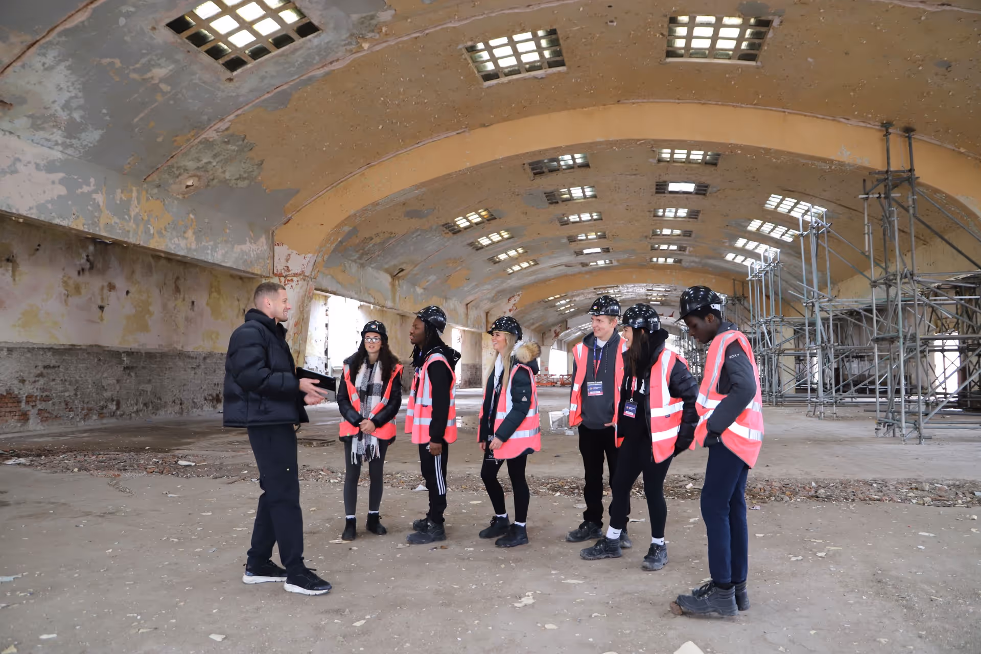 Capital&Centric team talking to a group of young people on a worksite.